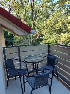 a patio with two chairs and a table on a balcony at Apartament Snow White in Karpacz +1 photo