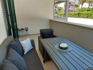 a living room with a table and a couch at Dalmatino - apartment 6 in Sutivan +37 photos