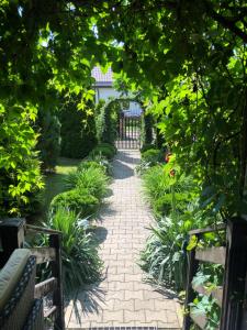 a garden path with a gate and plants at Zielona Sielanka in Orzyny