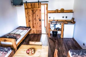 a room with two bunk beds and a table at Apartmány Moravský Grunt in Olomouc