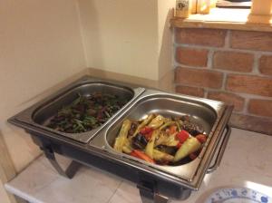 a tray of food on a table with vegetables at Pension Aura Špičák, některé pokoje se saunou in Železná Ruda