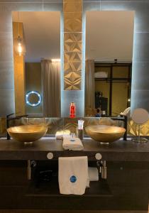 a bathroom with two sinks and a large mirror at Mamma Mia Hotel Boutique - Only Adults in Tossa de Mar