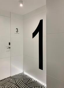 a number in a white wall with a floor at Mamma Mia Hotel Boutique - Only Adults in Tossa de Mar