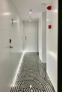 a hallway with a zebra pattern on the floor at Mamma Mia Hotel Boutique - Only Adults in Tossa de Mar