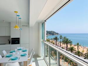 a dining room with a view of the ocean at Seafront New Apartment Boutique in Lloret de Mar