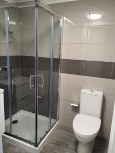 a bathroom with a toilet and a shower at Casa da Praça in Ponte de Sor