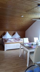 a bedroom with a bed and a table and chairs at Studio Apartment in Bermatingen