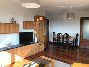 a living room with a television and a dining room table at Gibeleburu in Bermeo