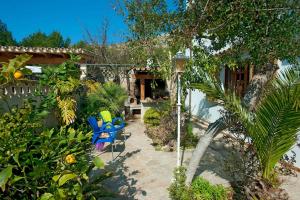 a patio with two blue chairs and a house at Villa Carla by Sealand Villas in Port de Pollensa +28 photos