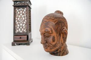 una statua di legno accanto a un oggetto di legno di Dodo Red - The House Of Travelers a Como