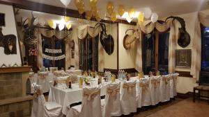 a banquet room with white tables and balloons at Семеен хотел Федора in Ribarica