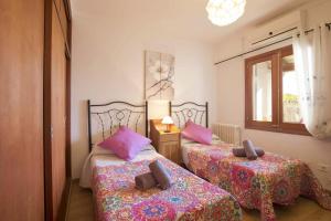 a bedroom with two beds and a window at Villa Tomeu by Sealand Villas in Port de Pollensa +17 photos