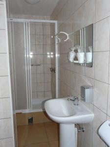 a bathroom with a sink and a shower at Hotel Turystyczny in Białystok
