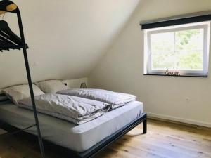 מיטה או מיטות בחדר ב-Vakantiewoning d'Hoppe