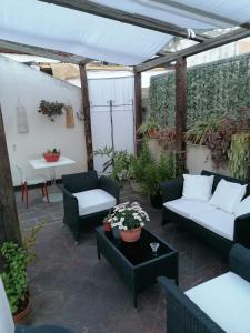 un patio con sofás y una mesa en Borgo Marinaro, en Aci Castello