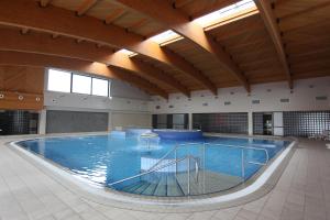 a large swimming pool in a large building at Hotel Central in Vitez