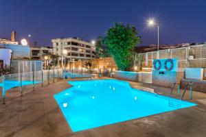 a swimming pool at night with blue lighting at Calypso Oasis Apartments in Puerto Rico de Gran Canaria