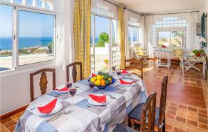 a dining room with a table with a view of the ocean at Nice Home In Vlez Mlaga With Wifi, Private Swimming Pool And Outdoor Swimming Pool in Algarrobo