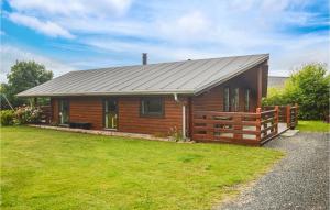 a log cabin with a metal roof at Awesome Home In Tarm With Sauna in Tarm