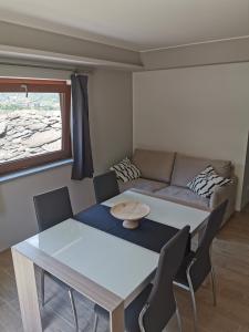 a living room with a table and a couch at La Maison D' Amelie in Fenis