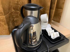 a black coffee maker sitting on top of a table at Hotel Heaven View - 50m From Golden Temple in Amritsar