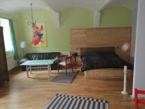 a bedroom with a bed and a couch and a table at Wohnung in Leipzig