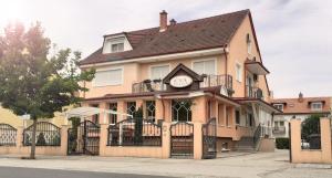 a building with a clock on the front of it at Éva Panzió in Sárvár