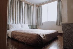 Postel nebo postele na pokoji v ubytování Tong Hsin Hotel