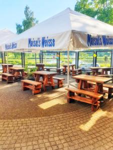 a group of picnic tables under a white tent at Vier Jahreszeiten, Appartment 723, Hahnenklee - Bockswiese in Goslar