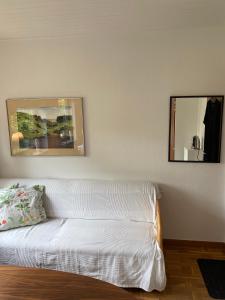 a white couch in a room with a mirror at Guesthouse Jensen Aarhus in Risskov