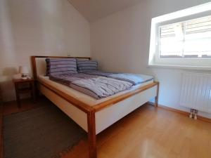 a bed sitting in a room with a window at Haus Tressenstein in Bad Aussee