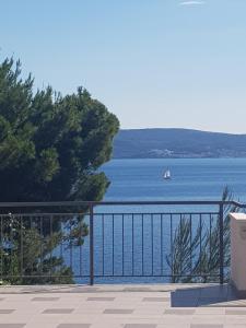 a view of the water with a sail boat in the distance at Apartments Garac in Dugi Rat