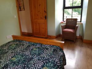 Ένα ή περισσότερα κρεβάτια σε δωμάτιο στο Rathgillen Lodge