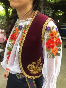 a woman wearing an embroidered shirt with a necklace at Etno Apartmani ''Vlaška kuća'' in Kladovo