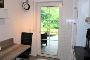 a kitchen with a door leading to a patio at FeWo an der Mühle in Bad Bentheim +17 photos