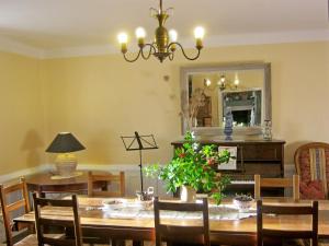 a dining room with a table and a mirror at Les Trois Chenes in Videix