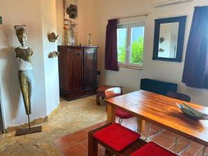 a dining room with a statue of a woman on the wall at Modern Red & Blue Apartment in Podstrana