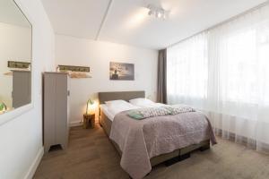 Postel nebo postele na pokoji v ubytování Het Vlielandhotel