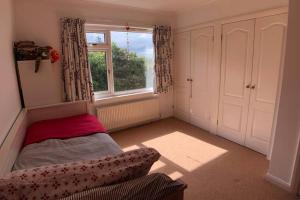 a small bedroom with a bed and a window at Nyth Y Wiwer, Spacious and Peaceful Bungalow Near Harlech in Llanfair