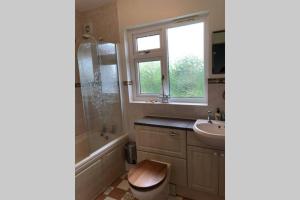 a bathroom with a sink and a toilet and a window at Nyth Y Wiwer, Spacious and Peaceful Bungalow Near Harlech in Llanfair +24 photos