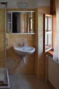 a bathroom with a sink and a mirror at Pont Vendégház in Kőszeg