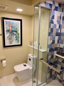 a bathroom with a toilet and a shower at New Cosy Apartment at Marvest Huahin City Center in Hua Hin
