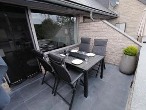 a black table and chairs on a patio at LA TERRASSE 226 in Malmedy