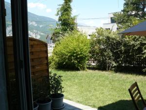 a view of a yard from the window of a house at STUDIO ENTRE SAVINES ET EMBRUN PRES DU LAC DE SERREPONçON in Crots