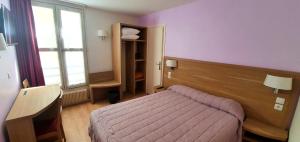 a small bedroom with a bed and a window at Hôtel des Pyrénées - Entre Bastille et Nation in Paris