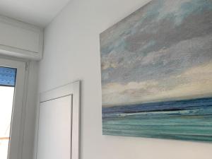 a painting hanging on a wall next to a door at Indipendent Blue in Ferrara