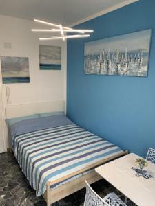 a bedroom with a bed and a blue wall at Indipendent Blue in Ferrara