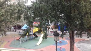a playground with a slide in a park at Hospedaje Torreón in Cangas de Onís