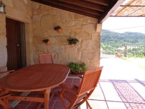 a wooden table and two chairs on a patio at casa rústica Cabo Home in Cangas de Morrazo