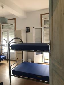 a room with two bunk beds and a refrigerator at Albergue San Martin in Tui